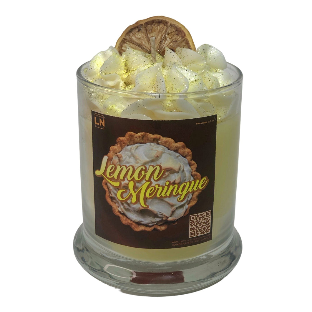 Vegan soy yellow Lemon Meringue Scented candle decorated with a white whipped topping and dried lemon slice inside a glass jar.